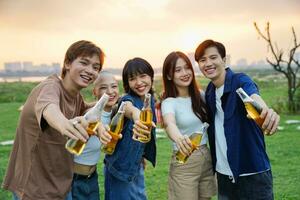 Image of group of friends celebrating and drinking beer together photo