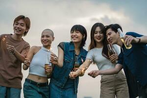 Image of group of friends celebrating and drinking beer together photo