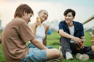 Image of group of friends celebrating and drinking beer together photo