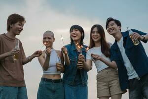 Image of group of friends celebrating and drinking beer together photo