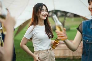 Image of group of friends celebrating and drinking beer together photo