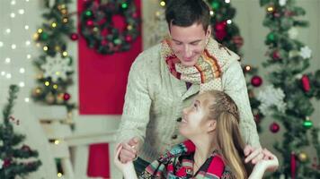 Young beautiful couple in sweaters and scarves playing hide and seek video