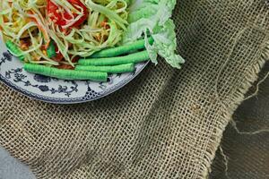 Delicious Thai food on the table in a restaurant in Thailand, papaya salad, larb, waterfall, sticky rice. top view, layout, flatlay photo