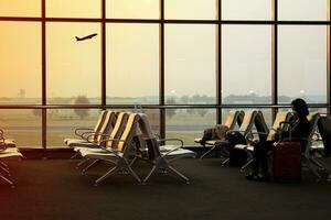Airport waiting area with chairs and luggage at airport terminal. Travel concept photo