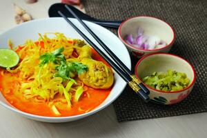 Thai Food, Khao Soi Kai, Thai spicy food, Thai spicy soup, Egg noodle in chicken curry photo