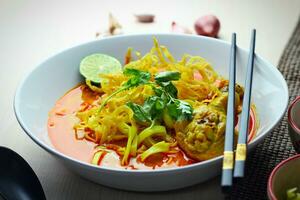 Thai Food, Khao Soi Kai, Thai spicy food, Thai spicy soup, Egg noodle in chicken curry photo