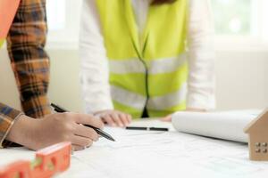 Engineers team discuss check and review the blueprint of construction. Contractor inspection drawing before start project civil. project planning, consulting, architecture. photo