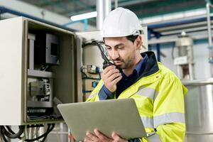 Mechanic or maintenance or electrical engineer checking main electrical control systems industrial plant. Utility fore man daily check power systems in process. Main Distribution Board, Switchboards photo