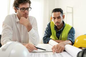 Engineers team and owner discuss check and review the blueprint of construction. Contractor inspection drawing before start project civil. project planning, consulting, architecture. photo