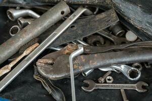 Hand tools with old rust wrench, bolts, keys photo