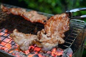 Grilled marinated pork on charcoal grill in dinner photo