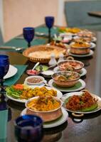 Various Indian food with meat, curry, soup and spicy taste on the table photo
