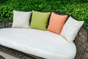 Pillows on mattress and weave wooden sofa photo