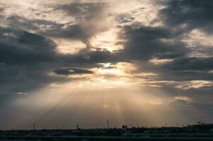 Golden sunray through clouds in the sky photo