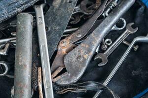 Hand tools with old rust wrench, bolts, keys photo