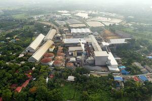 Processing factory of molasses and sugar with emission smoke from chimneys at countryside photo