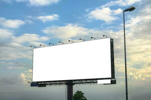 White large empty billboard with steel structure on side of road photo