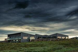 Visitor Gullfoss tourist centre with brandname shop, restaurant, souvenir and information service with dramatic sky on gloomy day photo