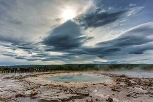 Strokkur Geyser eruption, natural hot spring pulsing in national park photo