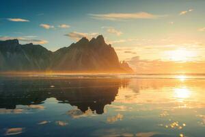 Golden sunrise over Vestrahorn mountain reflection on the beach in Stokksnes peninsula at Iceland photo