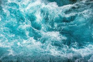 Natural texture crystal blue water rapids sea with air bubbles flowing motion photo