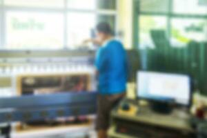 Blur scene worker during production inkjet printer photo