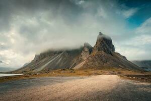 Moody Eystrahorn or Krossasnesfjall mountain with foggy covered in summer at Iceland photo