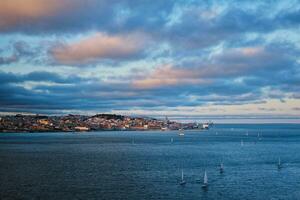 View of Lisbon view over Tagus river with yachts and boats at sunset. Lisbon, Portugal photo