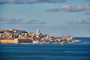 View of Lisbon view over Tagus river with yachts and boats at sunset. Lisbon, Portugal photo