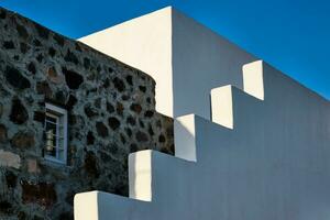 Greek architecture abstract background - whitewashed house with stairs. Milos island, Greece photo