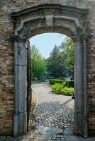 Brugge street architecture arch and old houses in Bruges, Belgium photo