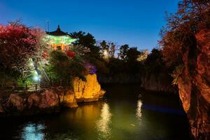 Yongyeon Pond with Yongyeon Pavilion illuminated at night, Jeju islands, South Korea photo