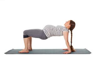 Pregnant woman doing yoga asana Purvottanasana photo