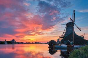 Windmills at Zaanse Schans in Holland on sunset. Zaandam, Nether photo