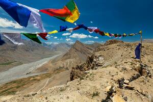 Buddhist prayer flags lungta with mantra written on it. Spiti Valley, India photo