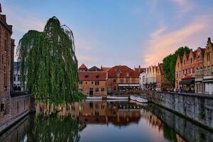 Bruges canal and houses at sunset. Brugge famous place, Belgium photo