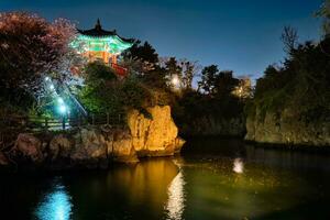 Yongyeon Pond with Yongyeon Pavilion illuminated at night, Jeju islands, South Korea photo