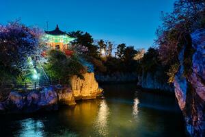 Yongyeon Pond with Yongyeon Pavilion illuminated at night, Jeju islands, South Korea photo