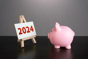 Pig piggy bank looking at 2024 year stand. Reflecting on past achievements and experiences. Embracing new trends, making forecasts, setting plans for the upcoming year. photo