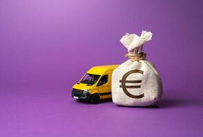 Euro money bag and delivery van. Freight transportation. Logistics industry, driver shortages. Last-mile delivery services. Supply chain resilience. Invest in electric and autonomous vehicles. photo