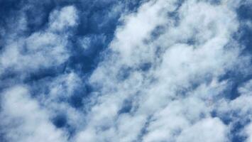 Blue sky and white clouds as seen through window of an aircraft. photo