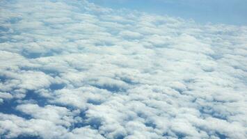 Blue sky and white clouds as seen through window of an aircraft. photo