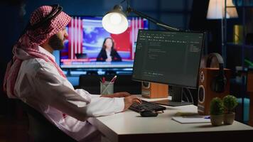 Qualified arab programmer writing code on computer screen while in office using Java programming languages. Middle Eastern Developer working on fixing database errors while working from home video