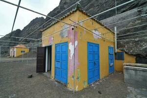 a yellow building with blue doors and windows photo