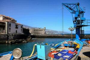 a blue fishing boat docked at the dock photo