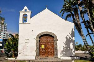 a small white church with a wooden door photo