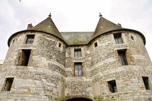 the castle is on top of a hill with a cloudy sky photo