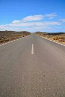 an empty road at middle of desert photo