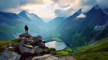 AI generated a person standing on a rock overlooking a lake and mountains photo