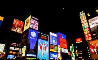 Osaka City, JP, 2019 - Perspective view and eye catching advertising neon lights billboards at Dotonburi area. Dotonbori is a one popular destination and landmark of Osaka for tourists. photo